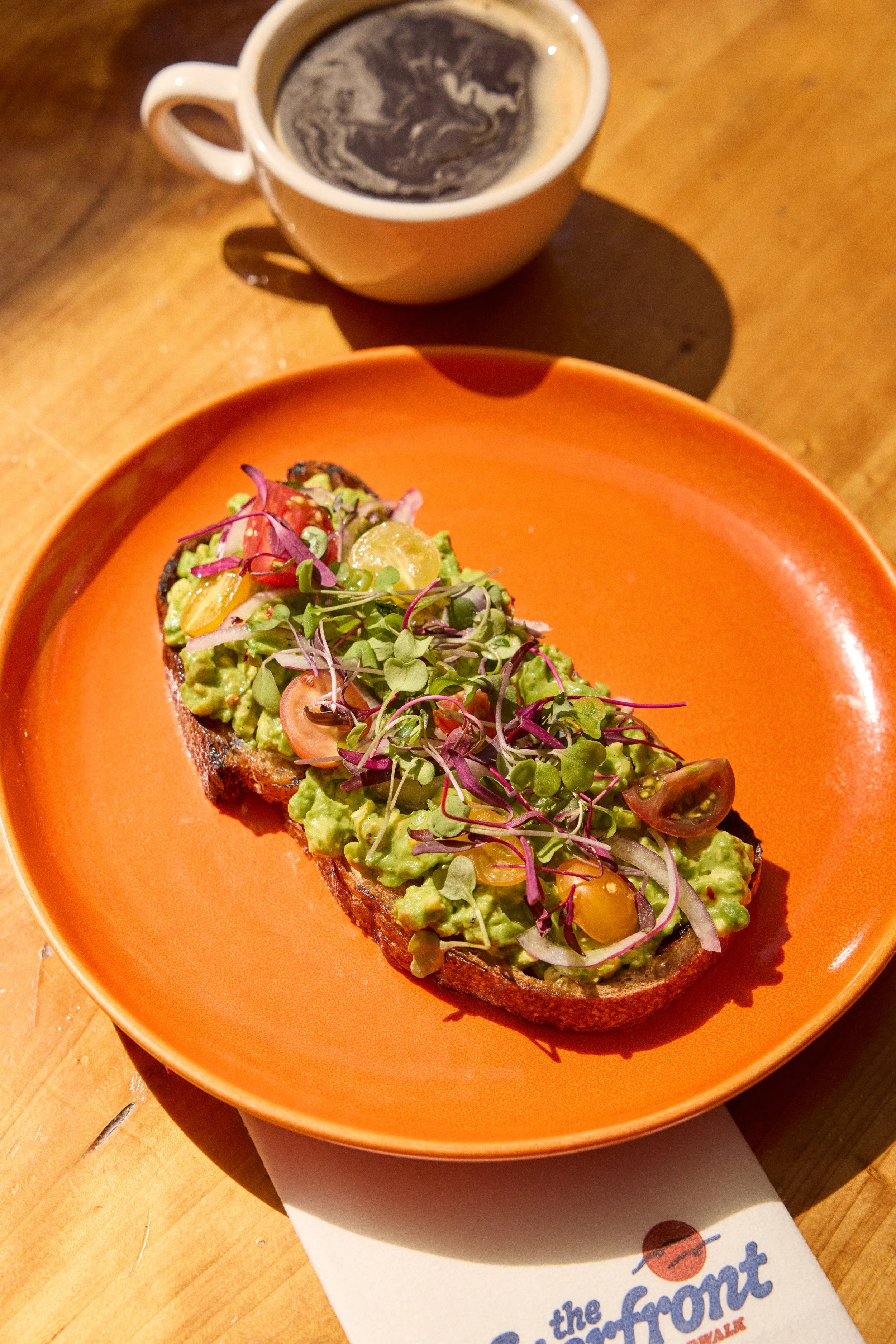 Plate of fish tacos with cabbage slaw and lime, served on a white plate.